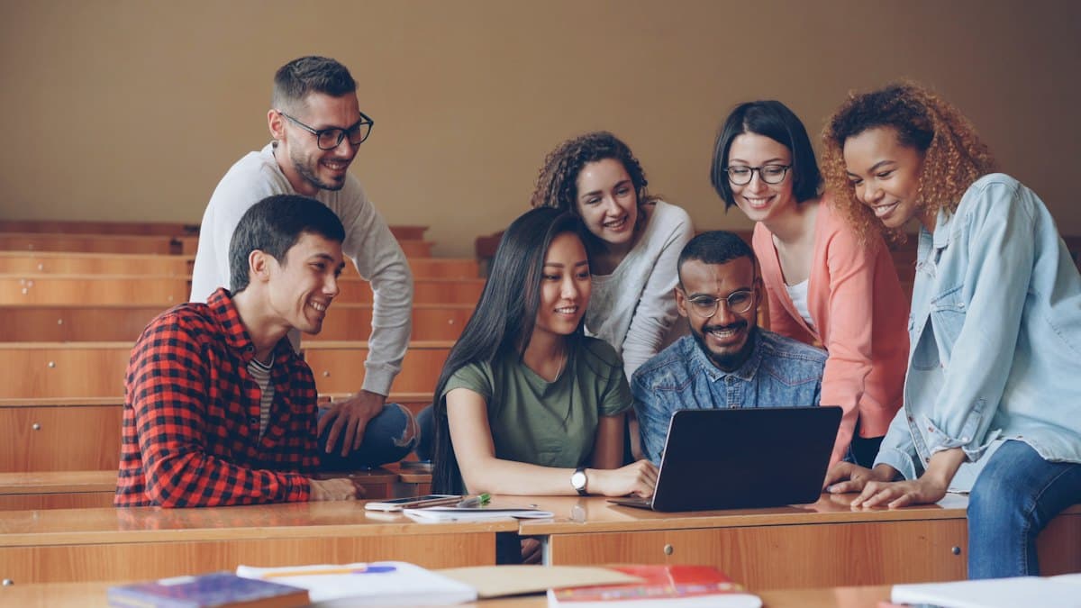 A group of participants collaborating around a laptop
